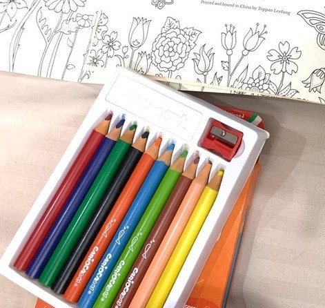 Colouring pencils on an open colouring book